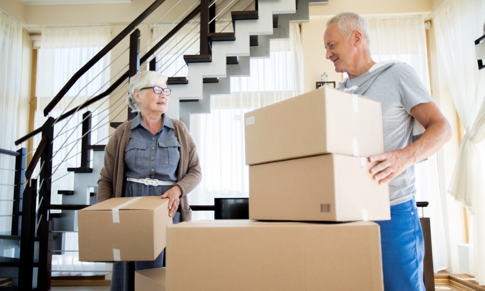 A man and a woman packing their home due to relocation